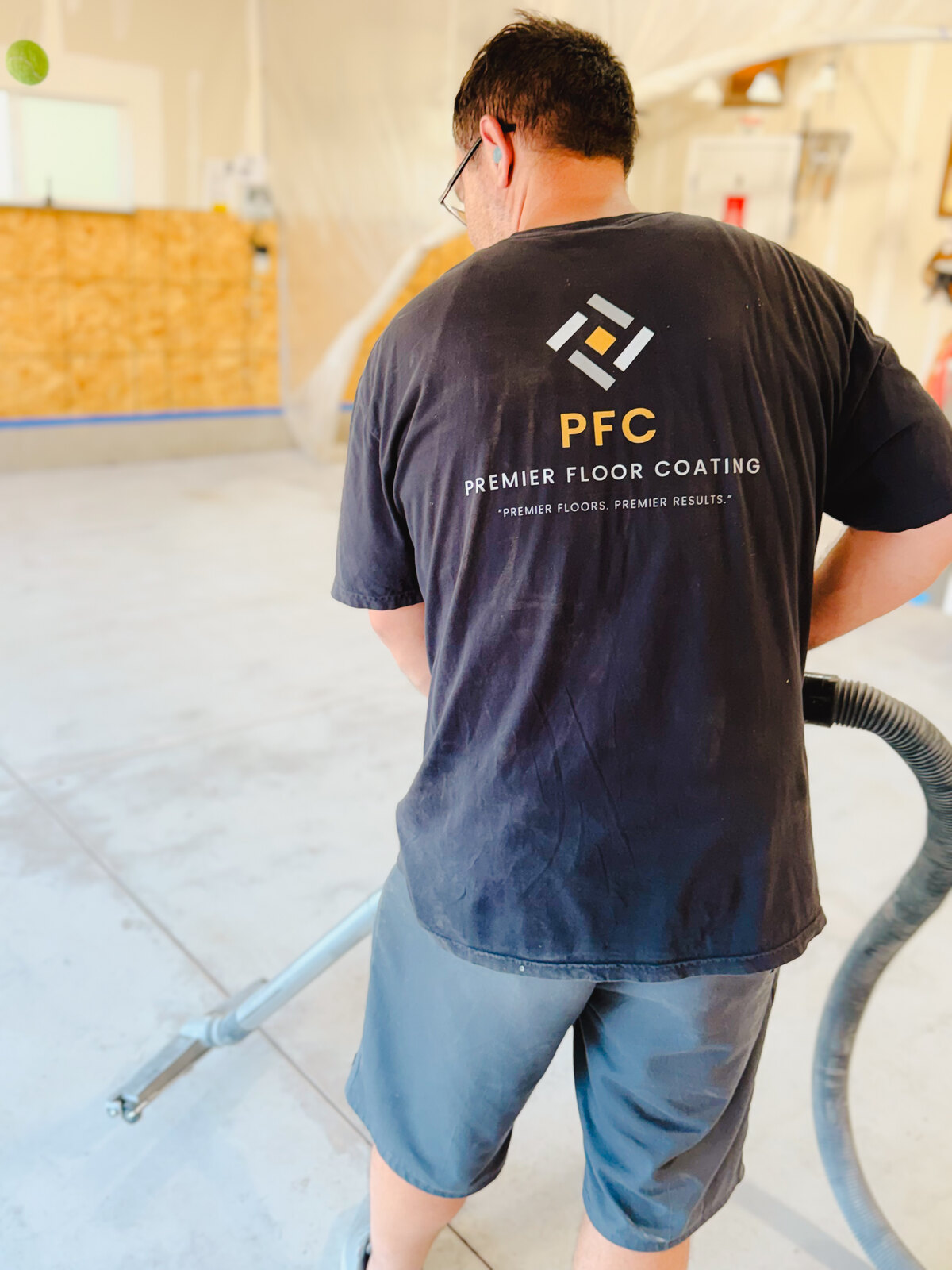 Nobis Concrete Coatings team member preparing a concrete floor